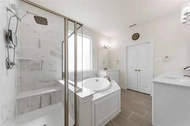 a bathroom with a granite countertop sink a toilet and shower