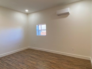 221 Howard Switch Road Hohenwald, TN 38462 - Photo 12 of 20 a view of empty room with wooden floor and fan