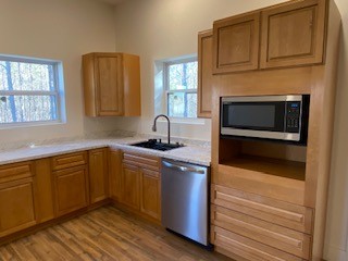 221 Howard Switch Road Hohenwald, TN 38462 - Photo 17 of 20 a kitchen with stainless steel appliances granite countertop a sink stove and microwave