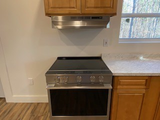 221 Howard Switch Road Hohenwald, TN 38462 - Photo 19 of 20 a stove top oven sitting inside of a kitchen
