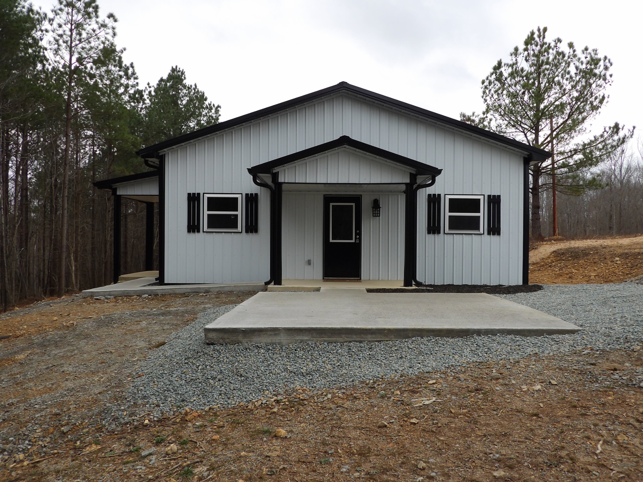 221 Howard Switch Road Hohenwald, TN 38462 - Photo 2 of 20 a front view of house with yard and trees in the background