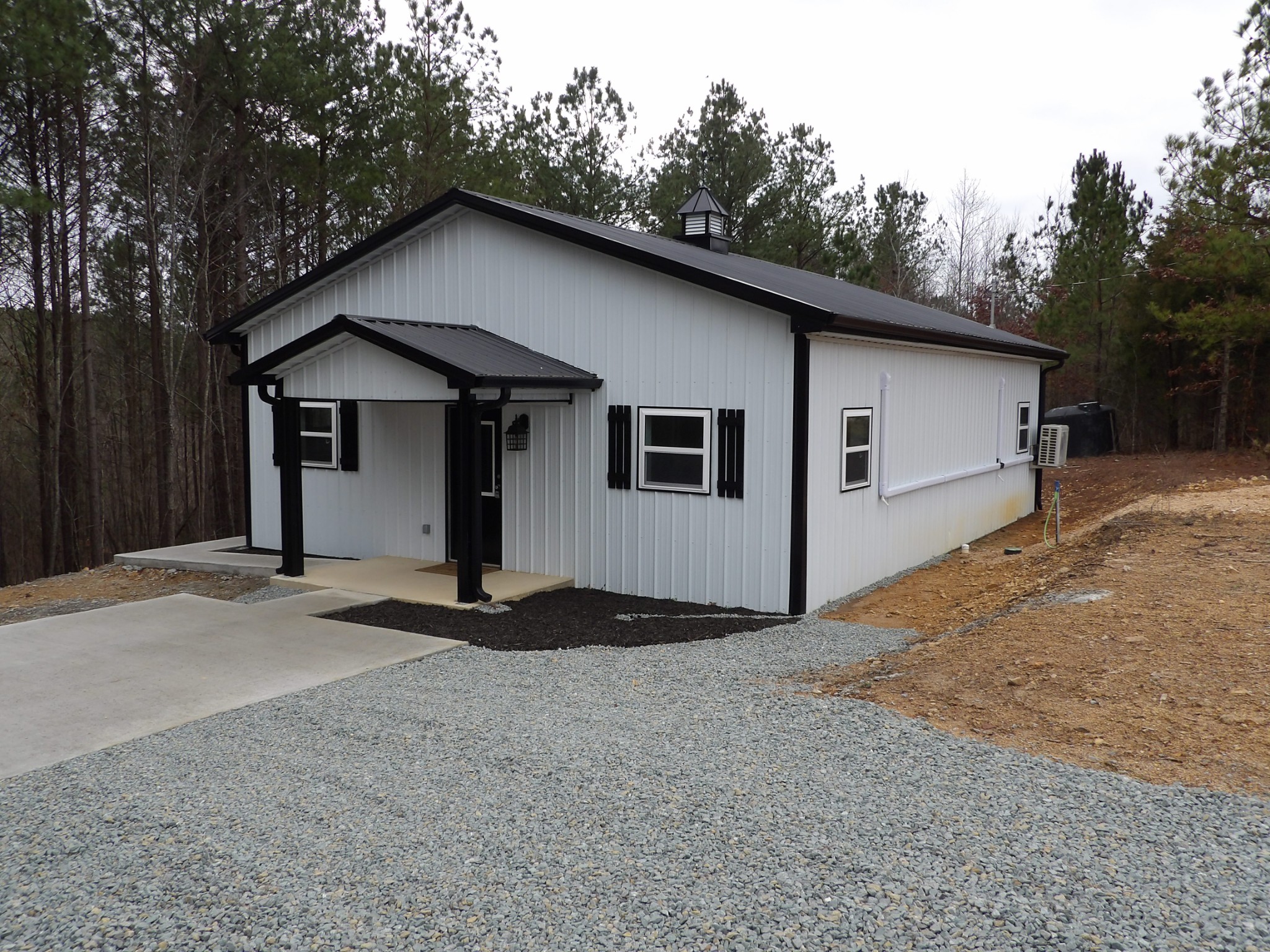 221 Howard Switch Road Hohenwald, TN 38462 - Photo 5 of 20 a side view of a house with a yard