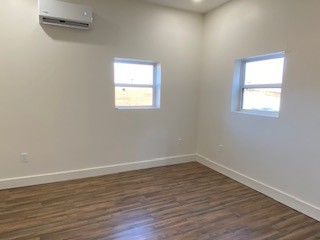 221 Howard Switch Road Hohenwald, TN 38462 - Photo 8 of 20 wooden floor in an empty room with a window