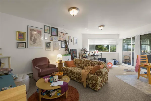 a living room with furniture and a lamp