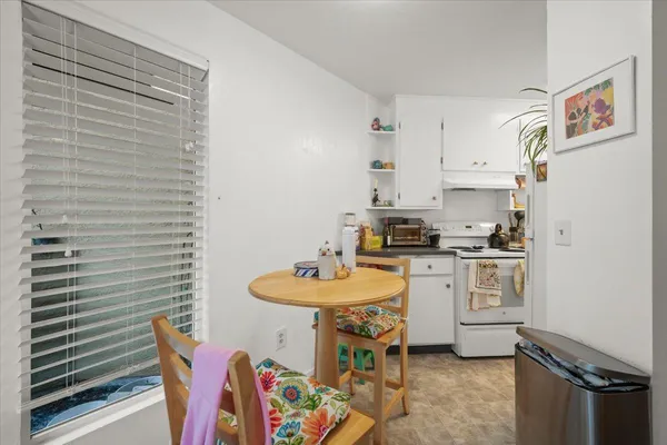 a kitchen with stainless steel appliances kitchen island granite countertop a sink and cabinets