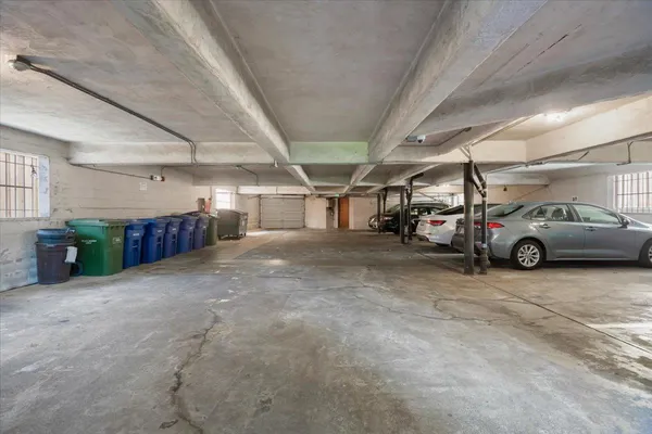 a view of parking garage with cars parked
