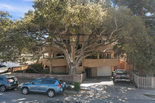 a car parked in front of a white house