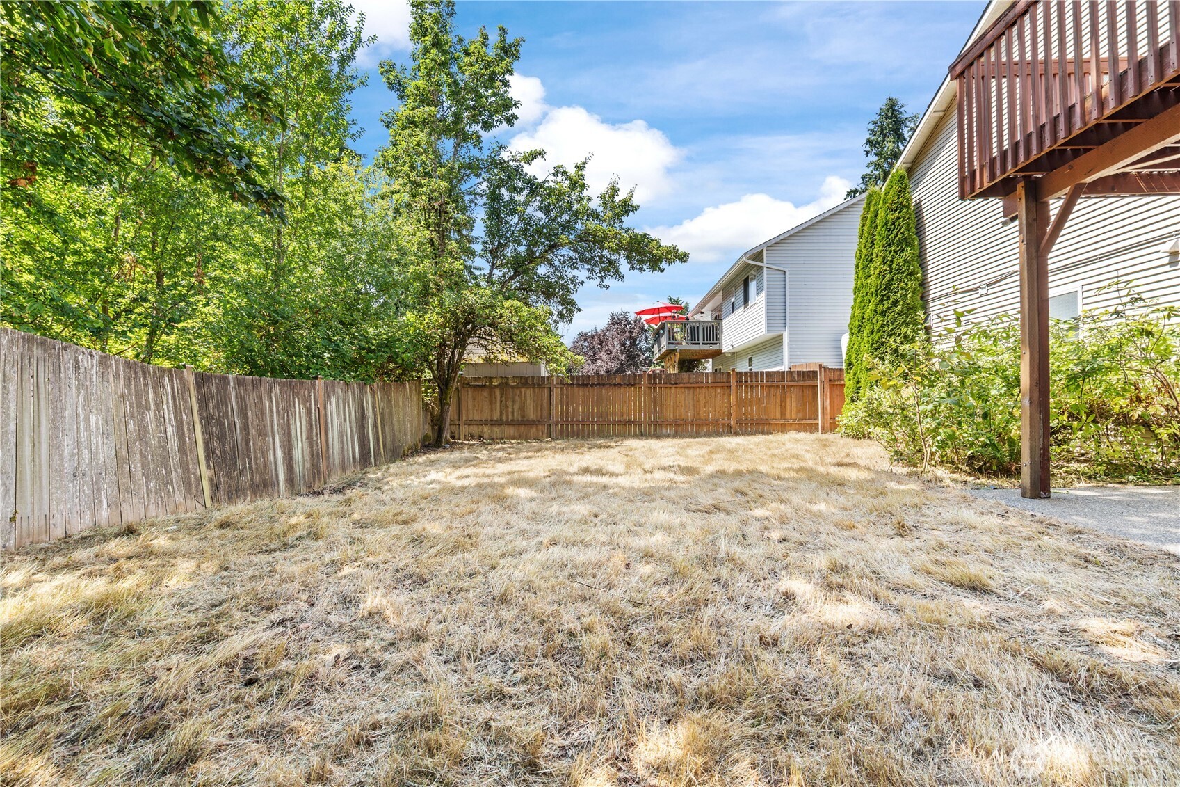 5620 Seahurst Avenue Everett, WA 98203 - Photo 27 of 28 a view of backyard with tree and wooden fence