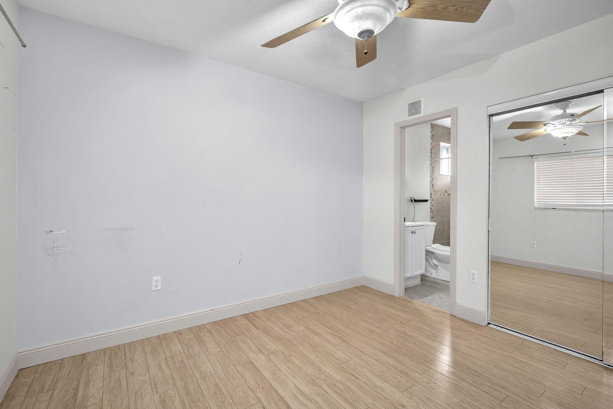 15225 Southwest 235th Street Homestead, FL 33032 - Photo 22 of 96 wooden floor in an empty room with a window