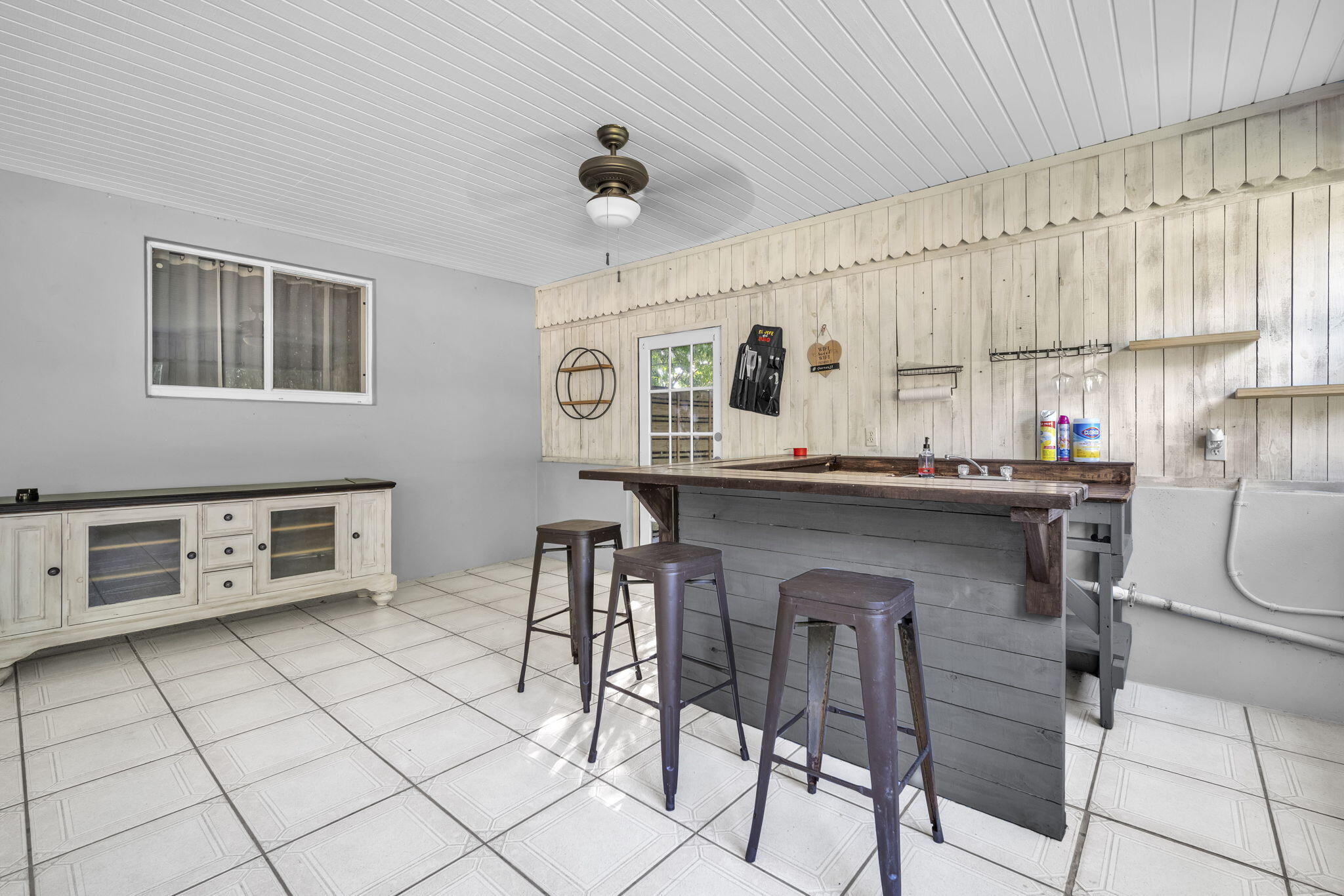 15225 Southwest 235th Street Homestead, FL 33032 - Photo 31 of 96 a kitchen with stainless steel appliances kitchen island granite countertop a table chairs sink and cabinets