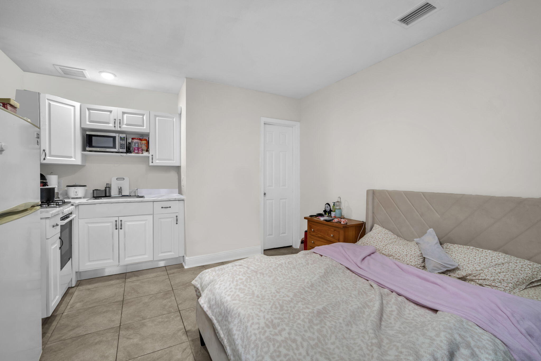 15225 Southwest 235th Street Homestead, FL 33032 - Photo 41 of 96 a bedroom with a bed and a view of kitchen