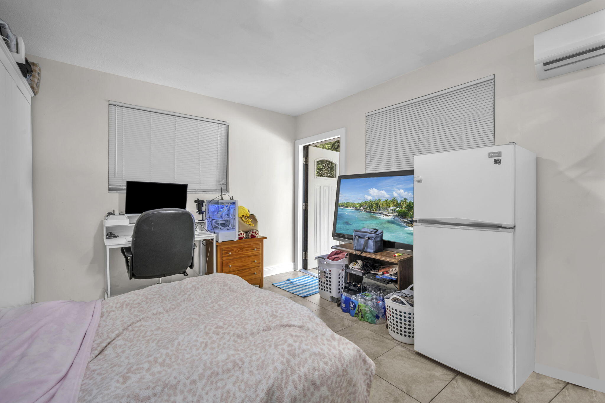 15225 Southwest 235th Street Homestead, FL 33032 - Photo 42 of 96 a bedroom with a bed and a refrigerator
