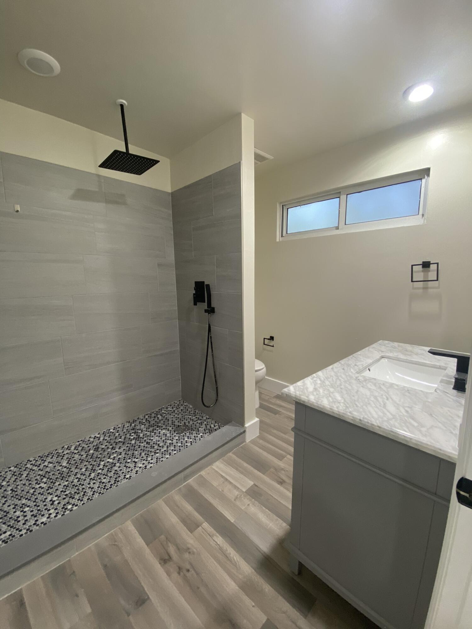 15225 Southwest 235th Street Homestead, FL 33032 - Photo 52 of 96 a bathroom with a granite countertop sink a toilet and shower