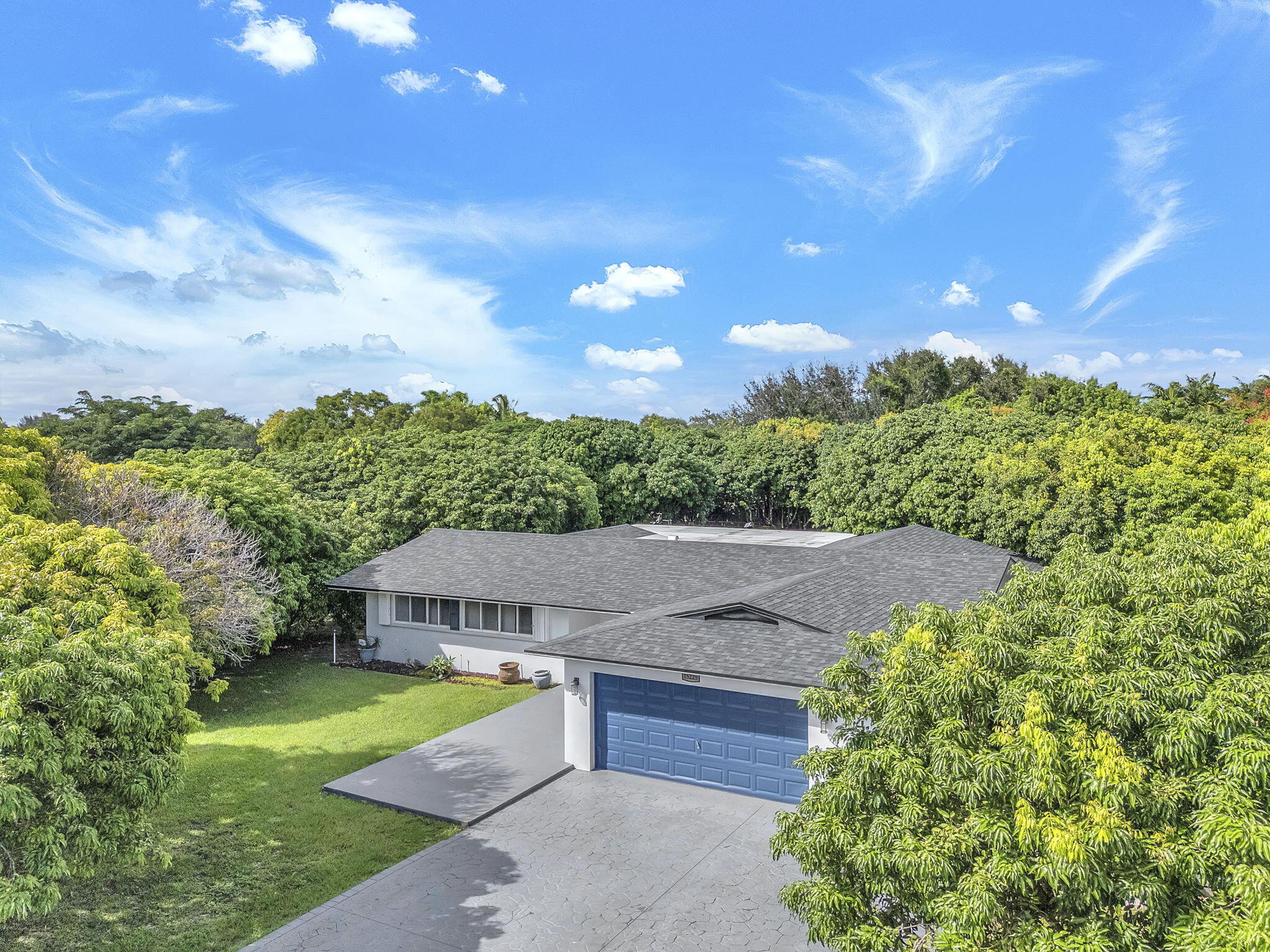 15225 Southwest 235th Street Homestead, FL 33032 - Photo 79 of 96 a view of a garden with a house in the background