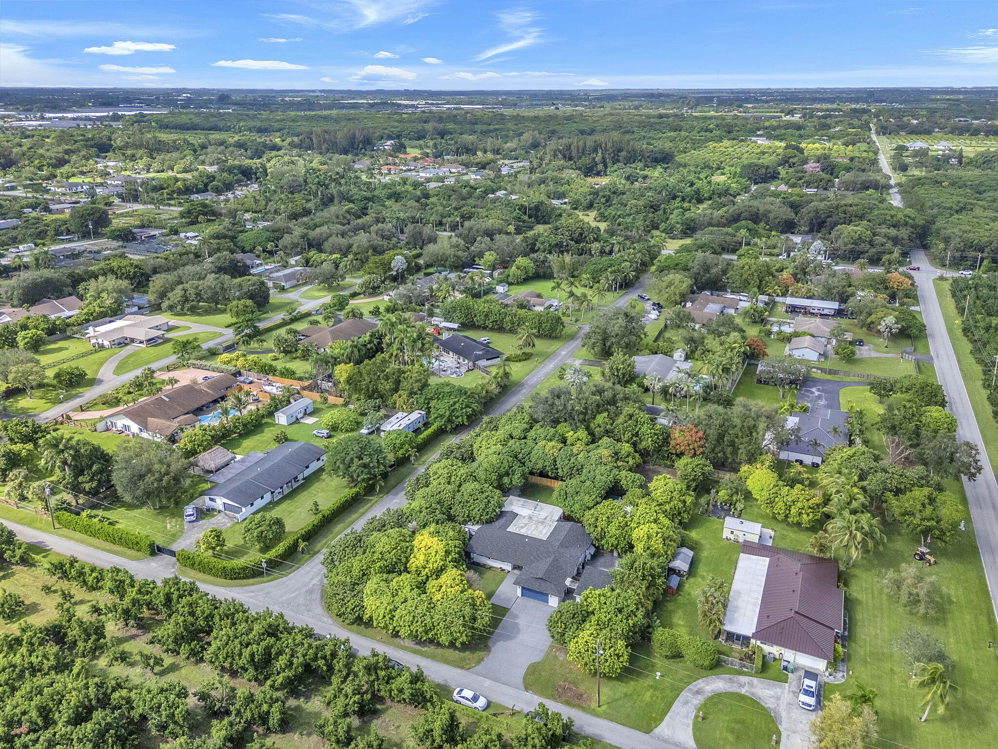 15225 Southwest 235th Street Homestead, FL 33032 - Photo 85 of 96 an aerial view of residential houses with outdoor space and trees