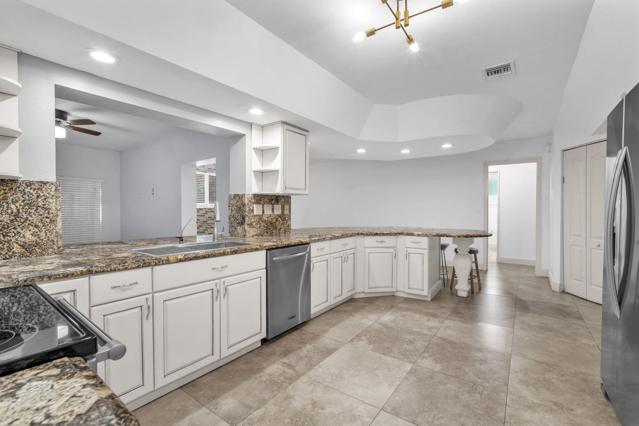 15225 Southwest 235th Street Homestead, FL 33032 - Photo 10 of 96 a large white kitchen with a large window