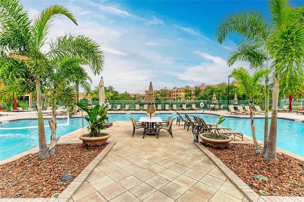 a view of swimming pool with outdoor seating and plants
