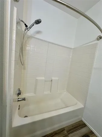 a spacious bathroom with double vanity and a mirror