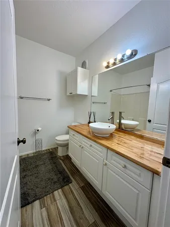 a view of a hallway with wooden floor and entryway