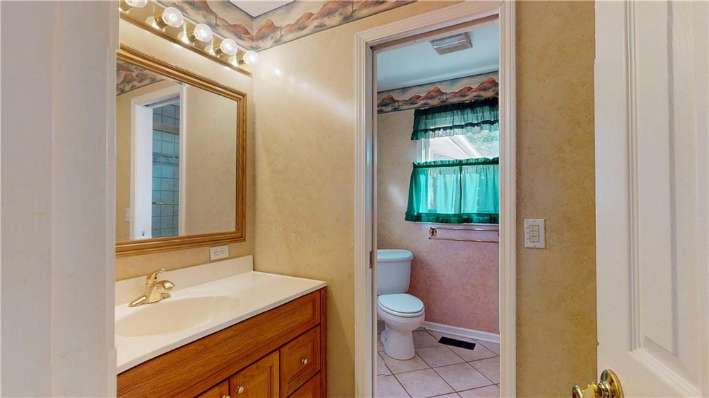 40 Lois Road Southwest Euharlee, GA 30120 - Photo 18 of 37 a bathroom with a granite countertop sink mirror vanity and toilet