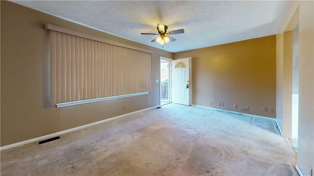 40 Lois Road Southwest Euharlee, GA 30120 - Photo 7 of 37 an empty room with a ceiling fan and a window