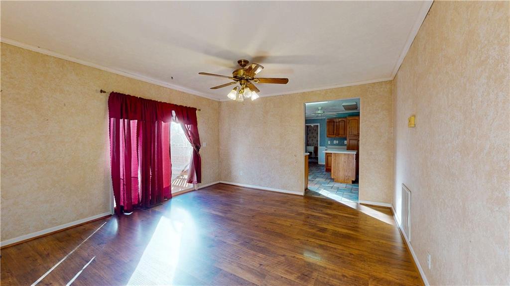 40 Lois Road Southwest Euharlee, GA 30120 - Photo 10 of 37 an empty room with wooden floor and a ceiling fan
