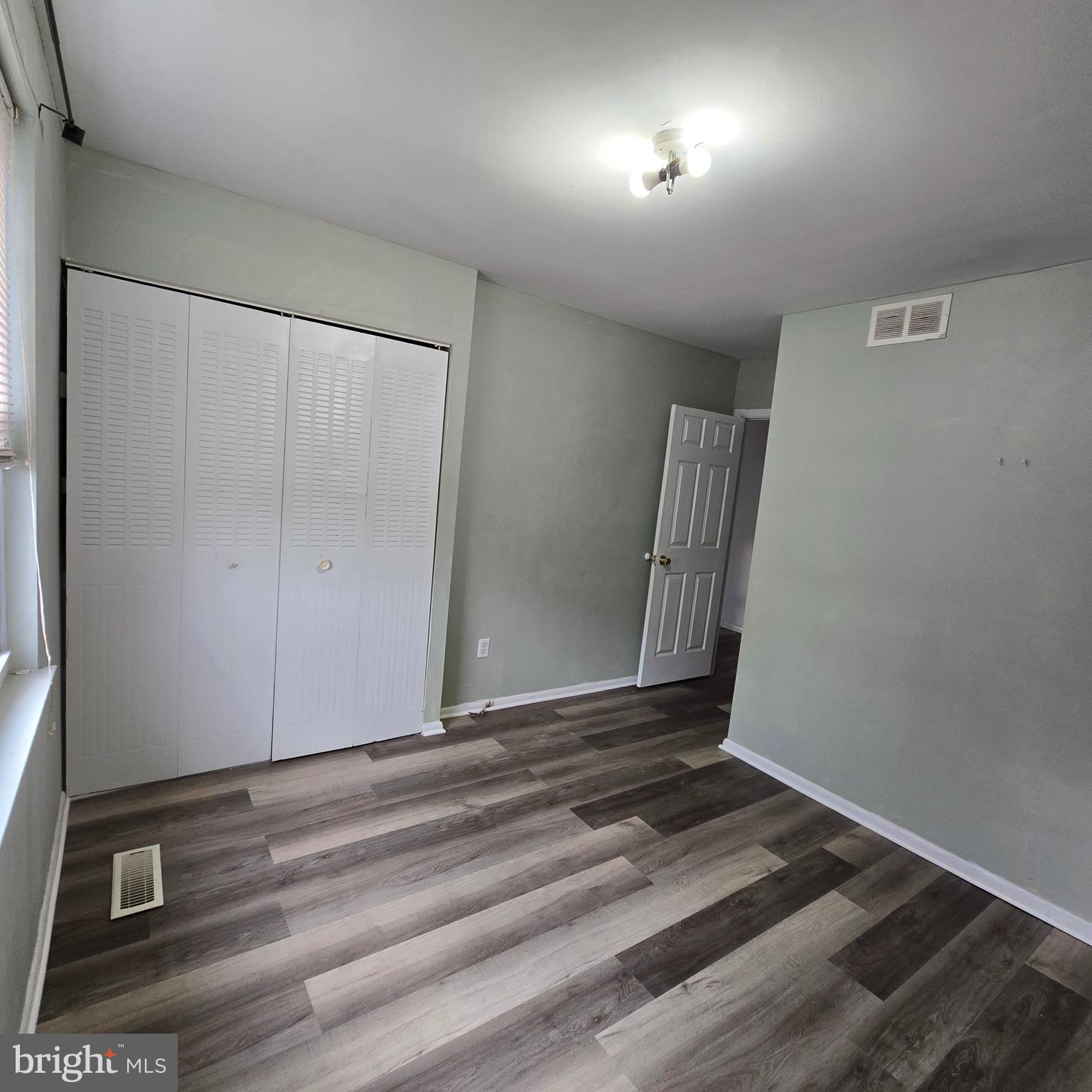 206 Hollybush Place Clementon, NJ 08021 - Photo 15 of 17 an empty room with wooden floor and windows