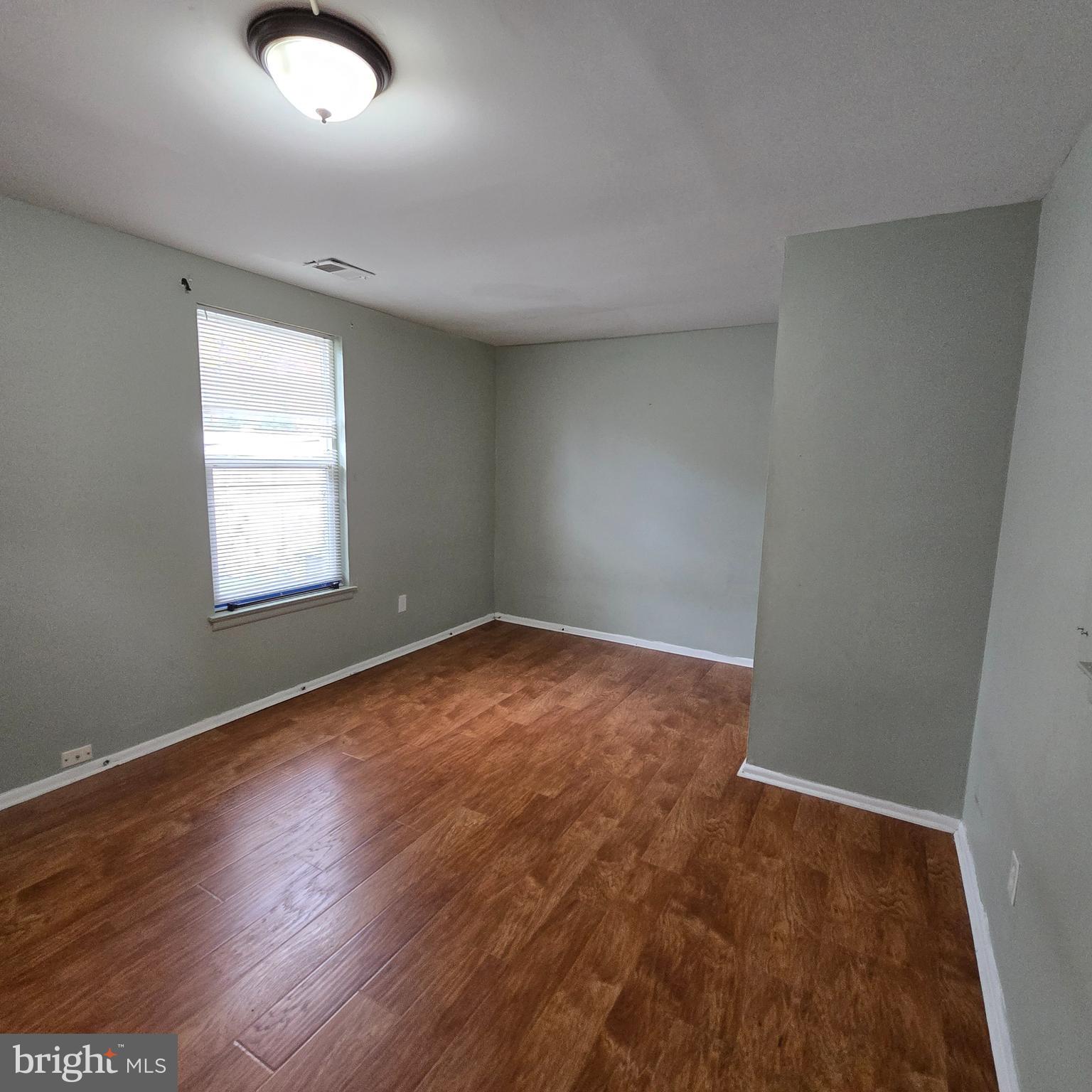 206 Hollybush Place Clementon, NJ 08021 - Photo 7 of 17 an empty room with wooden floor and windows