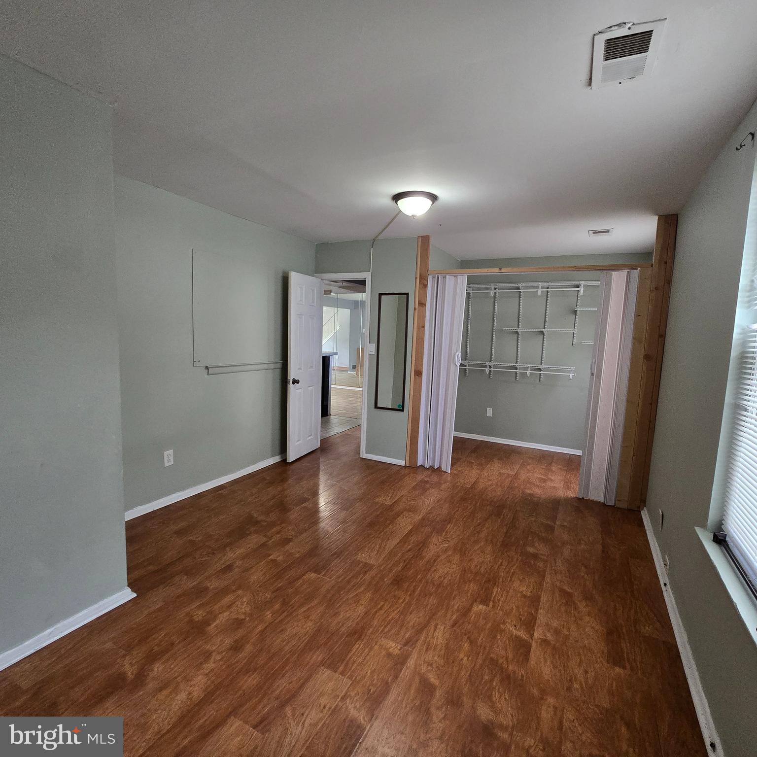206 Hollybush Place Clementon, NJ 08021 - Photo 8 of 17 a view of empty room with wooden floor and fan