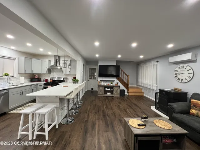 a large kitchen with a table and chairs