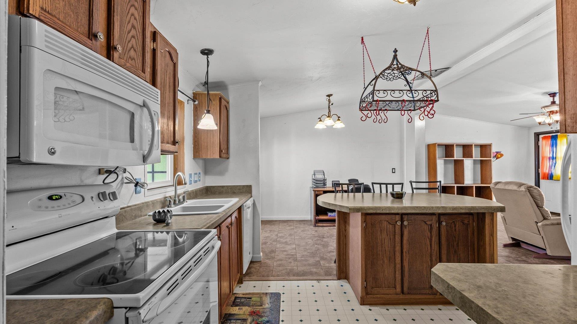 777 1550th Road Delta, CO 81416 - Photo 13 of 32 a kitchen that has a sink a stove and a table