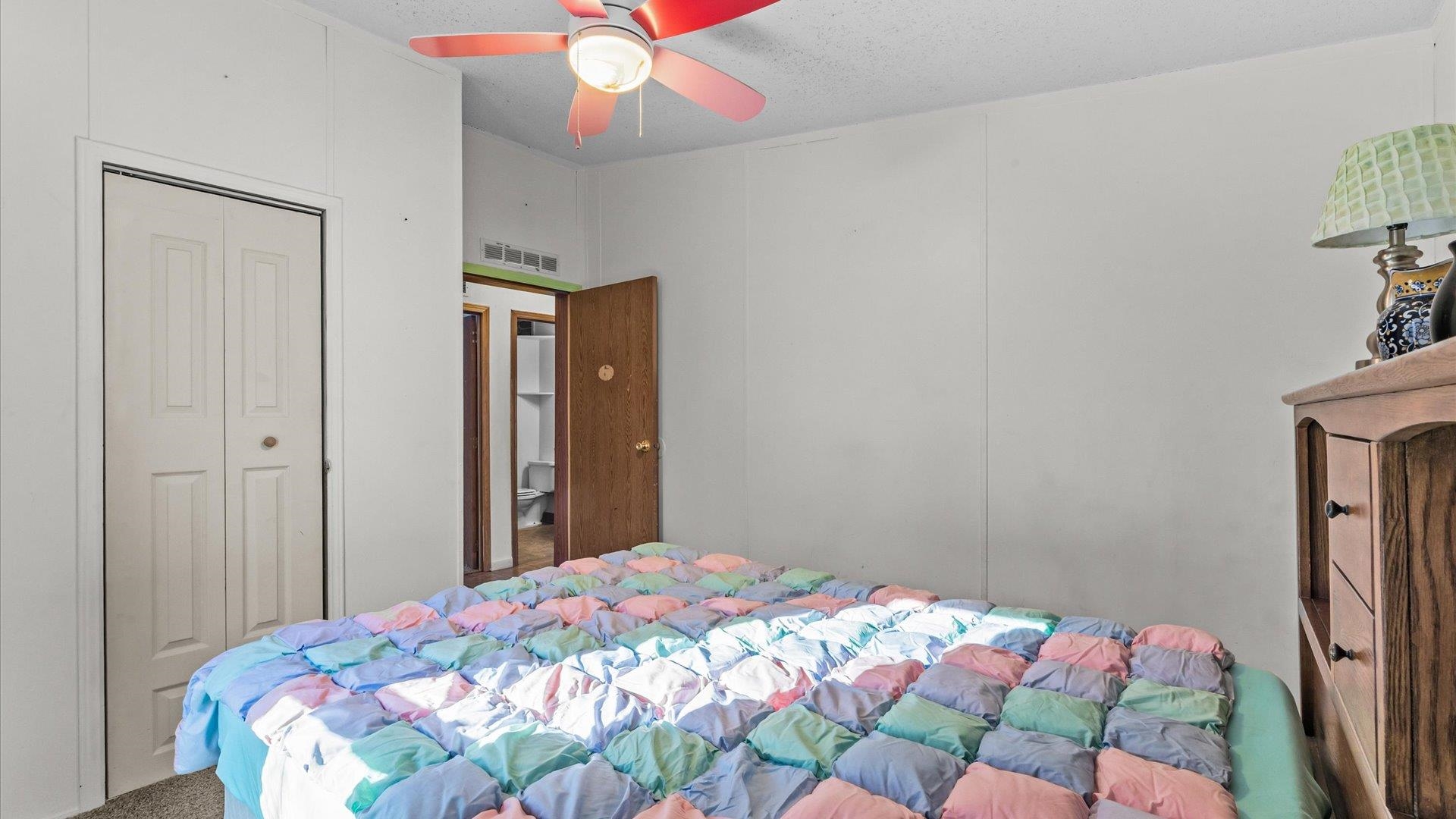 777 1550th Road Delta, CO 81416 - Photo 19 of 32 a bedroom with a bed and a chandelier