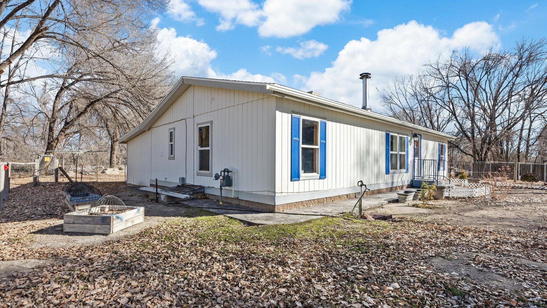 777 1550th Road Delta, CO 81416 - Photo 3 of 32 a front view of a house with garden