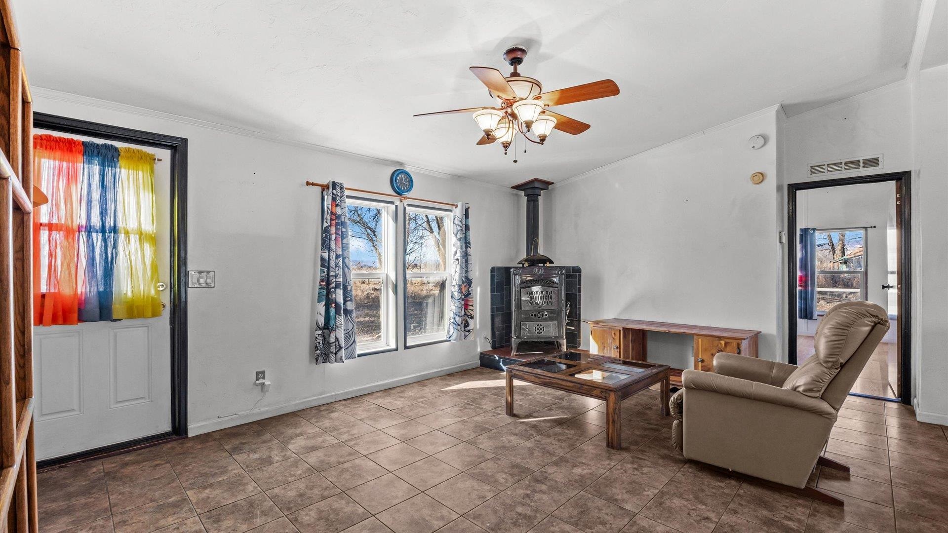 777 1550th Road Delta, CO 81416 - Photo 7 of 32 a living room with furniture a ceiling fan and a window