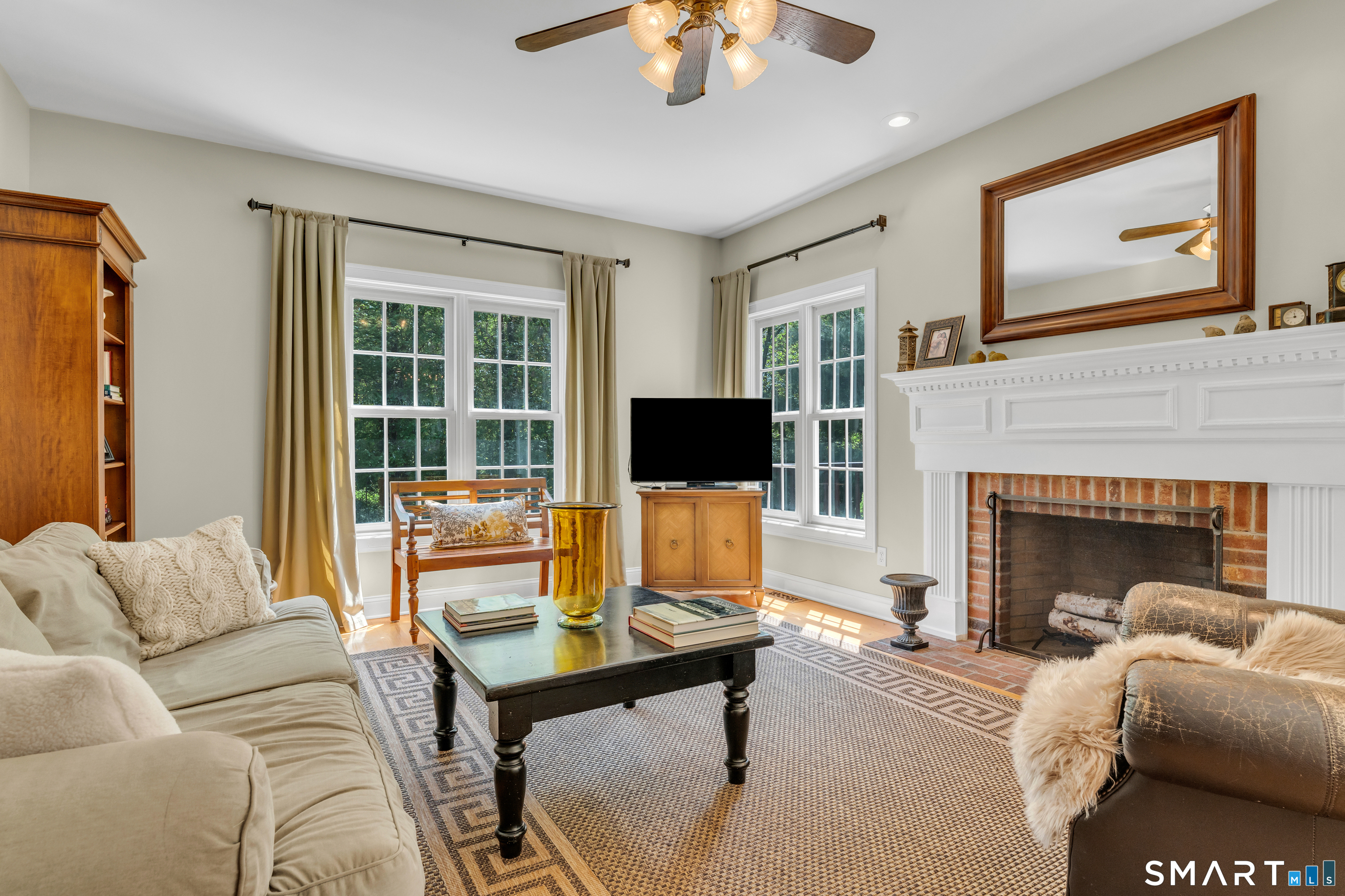 474 State Street Guilford, CT 06437 - Photo 17 of 40 a living room with furniture a flat screen tv and a fireplace