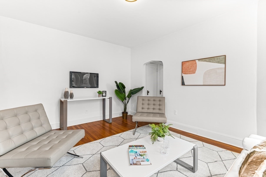 72 Strathmore Road, Unit 5B Boston, MA 02135 - Photo 3 of 18 a living room with furniture and wooden floor
