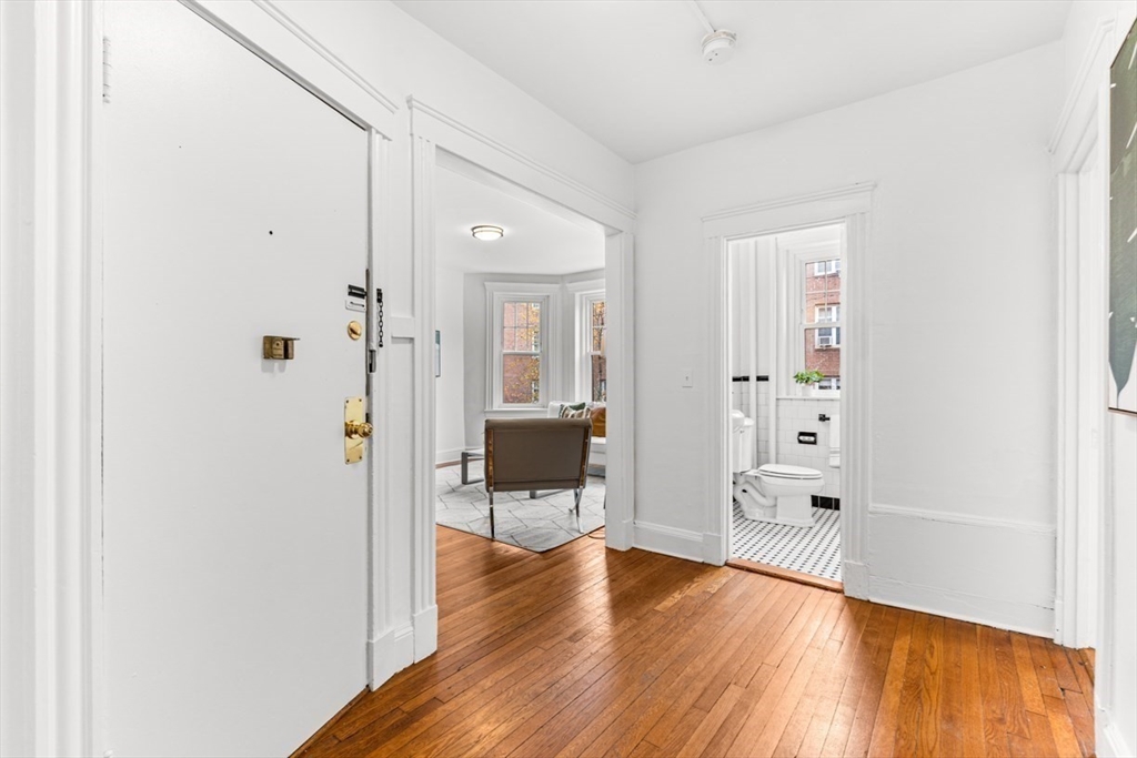 72 Strathmore Road, Unit 5B Boston, MA 02135 - Photo 5 of 18 a view of a hallway with wooden floor and a living room