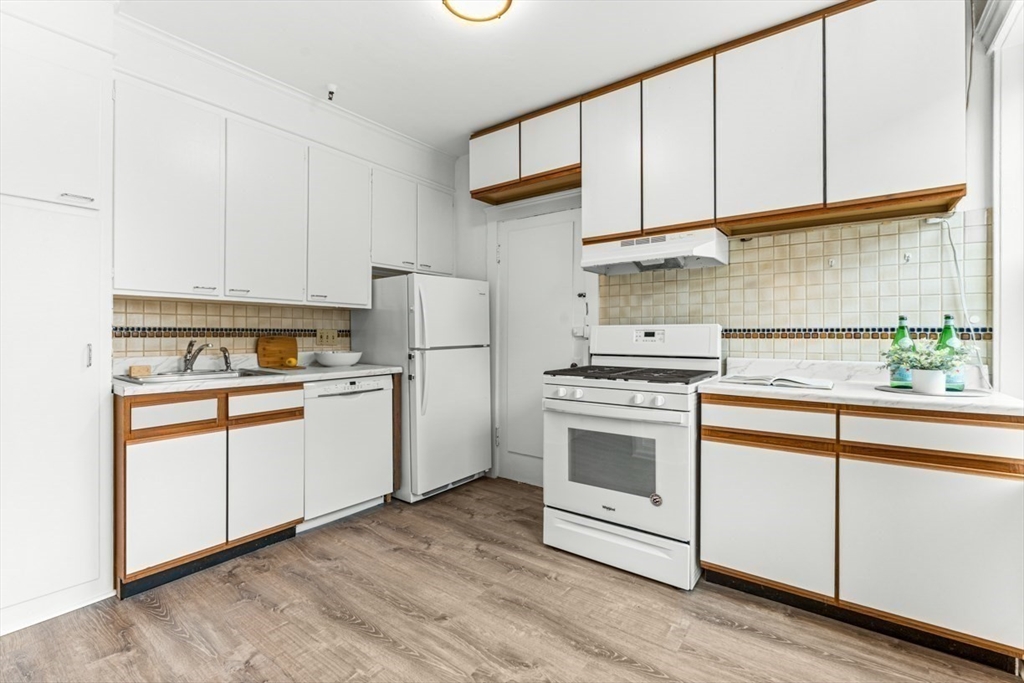 72 Strathmore Road, Unit 5B Boston, MA 02135 - Photo 7 of 18 a kitchen with white cabinets and white appliances
