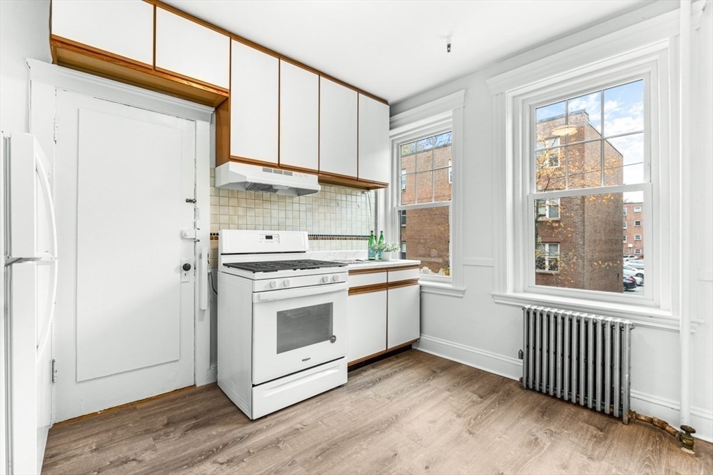 72 Strathmore Road, Unit 5B Boston, MA 02135 - Photo 8 of 18 a kitchen with a stove and a window