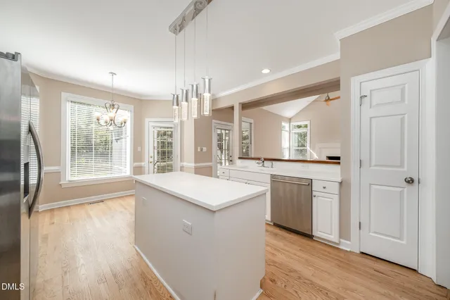 a large kitchen with a stove sink and refrigerator