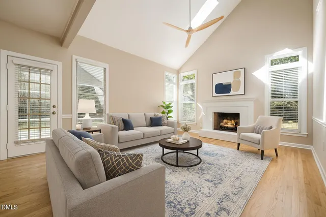 a view of a hallway with wooden floor and a kitchen