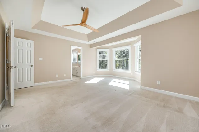 a spacious bedroom with a bed and window