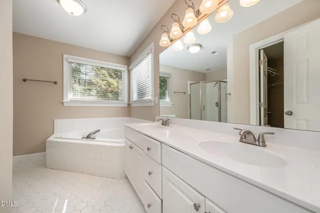 a bathroom with a tub a toilet and a shower