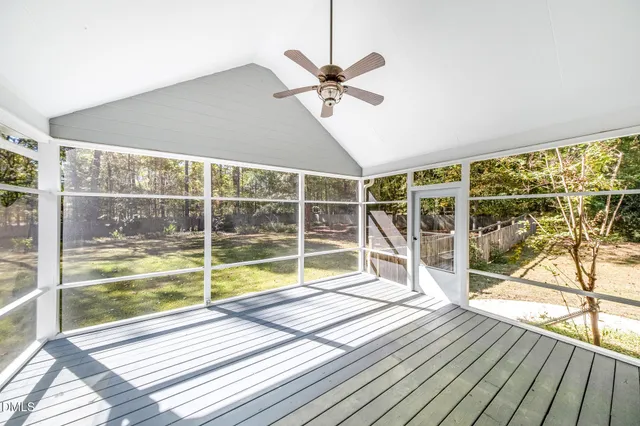 a view of a room with wooden floor and windows