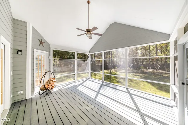 a view of swimming pool with large trees and a big yard