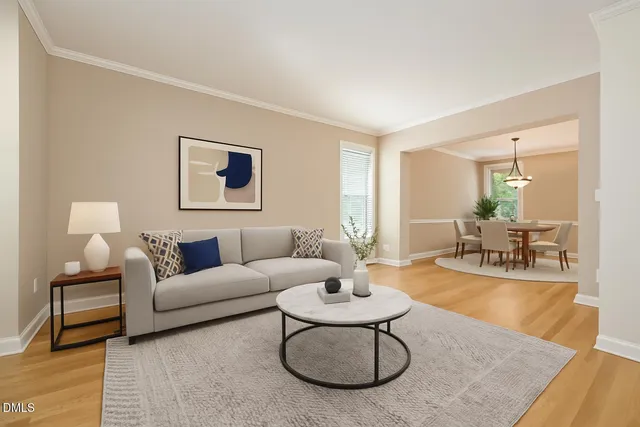 a living room with furniture a rug and a table