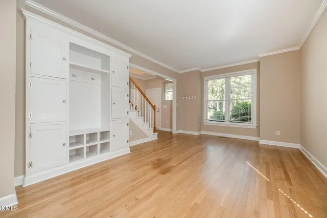 wooden floor in an empty room with a window
