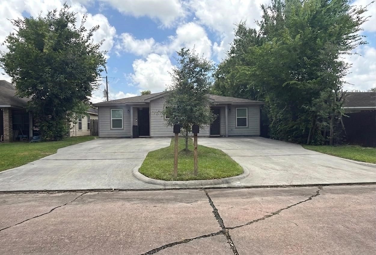 5626 Simsdale Street Houston, TX 77033 - Photo 1 of 10 a front view of a house with a yard