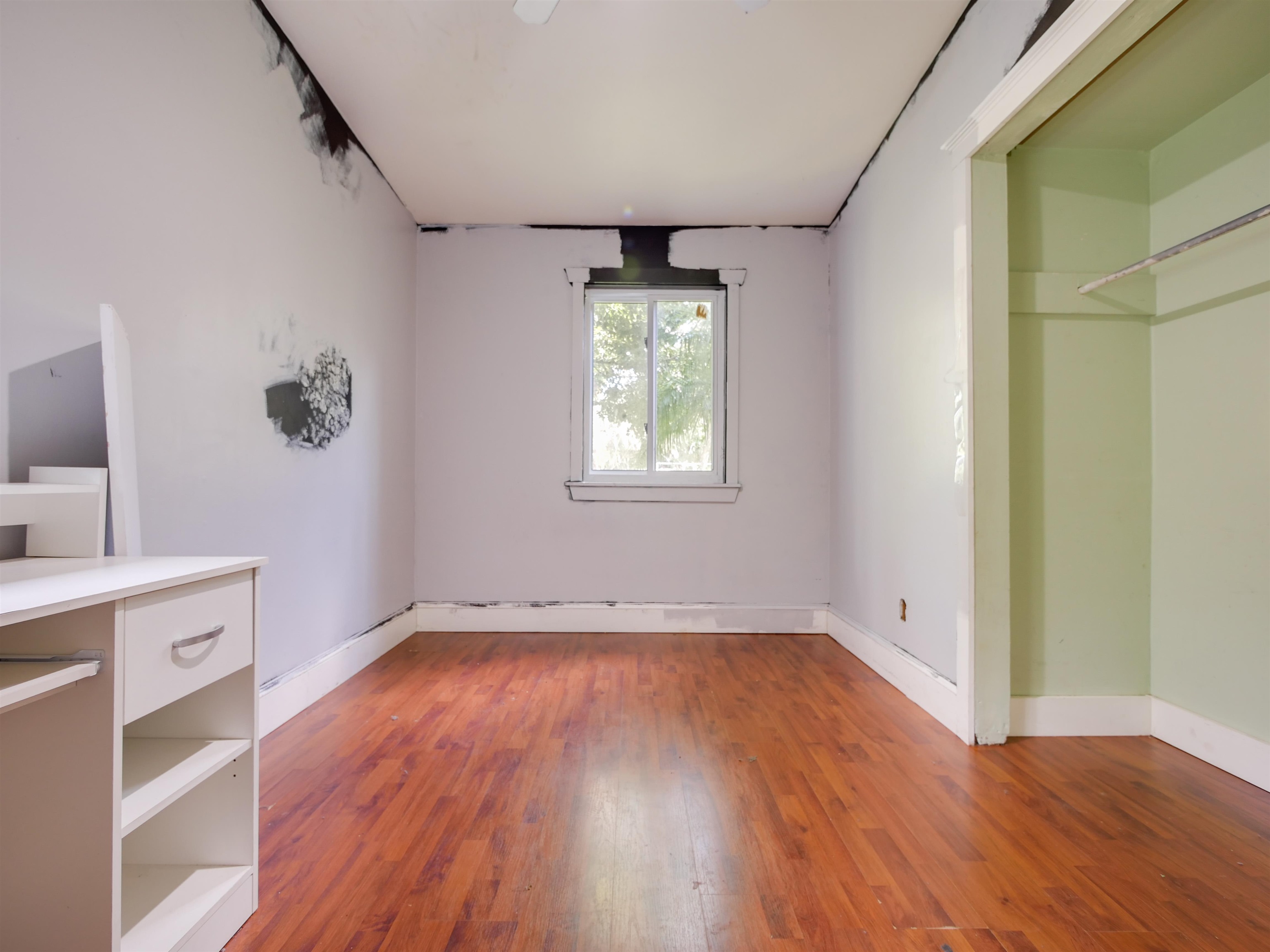 262 Spring Street St. Augustine, FL 32084 - Photo 13 of 25 wooden floor in an empty room with a window