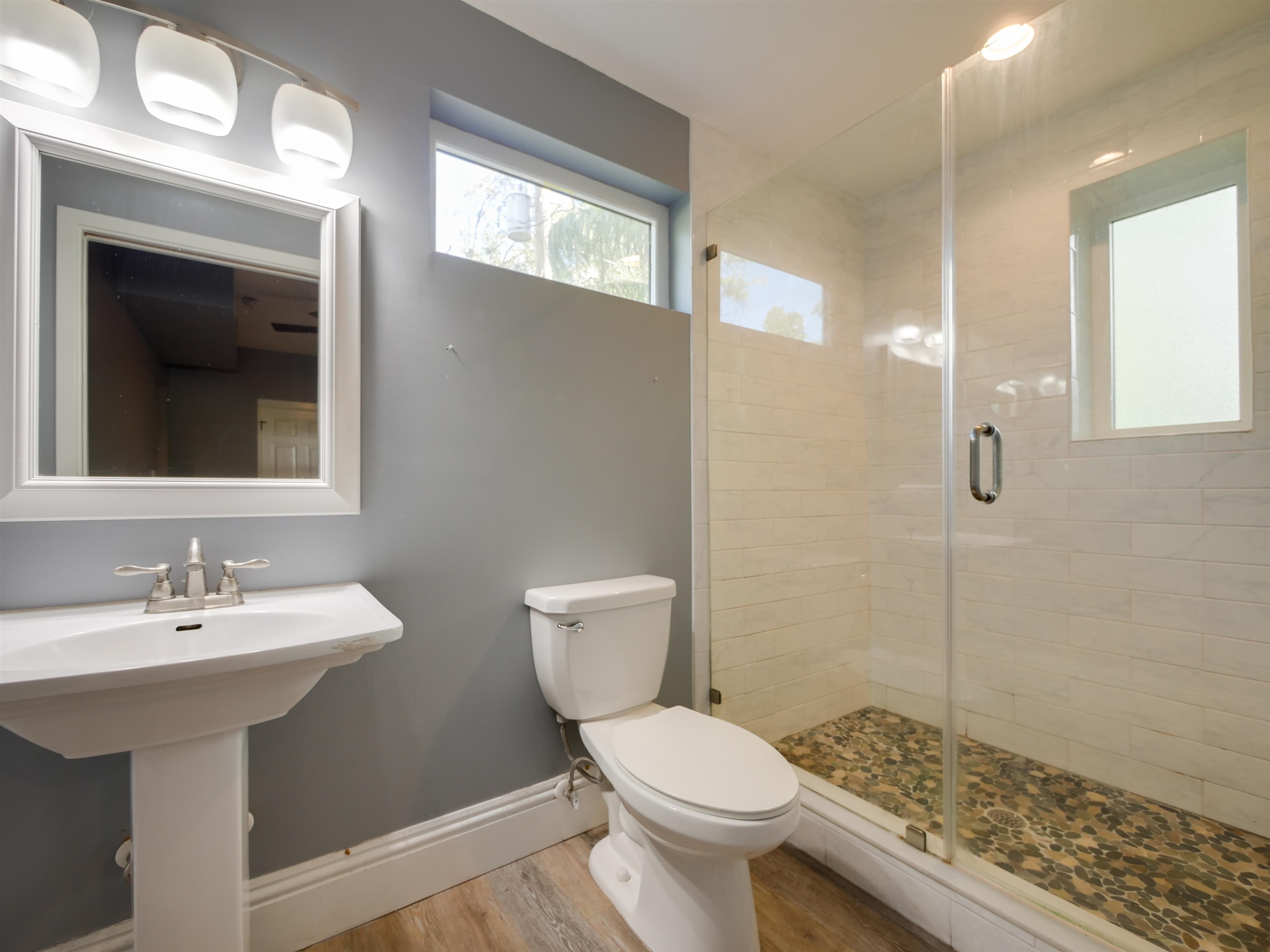 262 Spring Street St. Augustine, FL 32084 - Photo 15 of 25 a bathroom with a toilet a sink and mirror